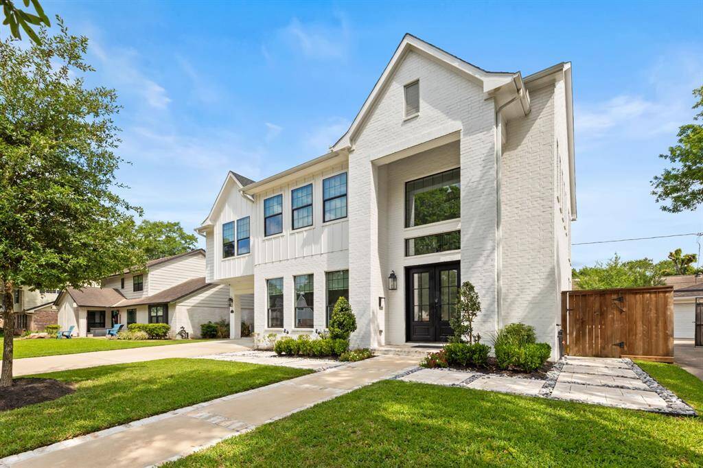 Striking curb appeal with modern design, lush landscaping, and a welcoming entryway, perfect for your new home
