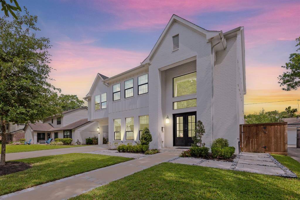 Striking curb appeal with modern design, lush landscaping, and a welcoming entryway, perfect for your new home