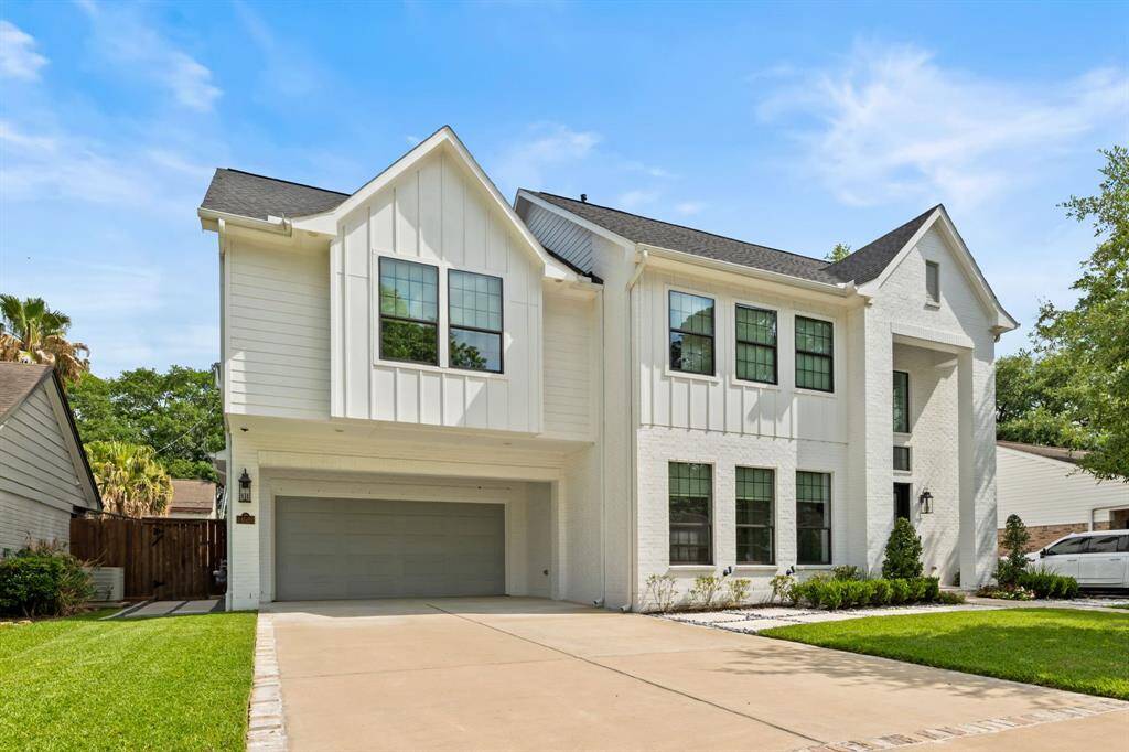 Spacious 2-car garage with full-length driveway for ample guest parking.