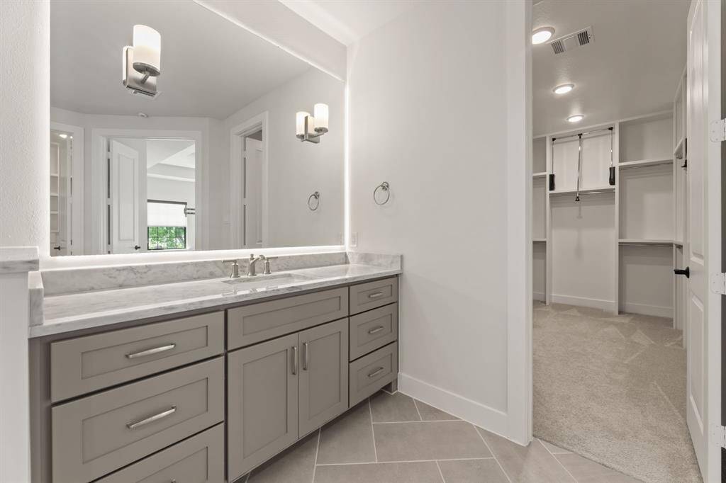 Elegant double vanity with ample storage and sleek fixtures, perfect for a luxurious bathroom experience.