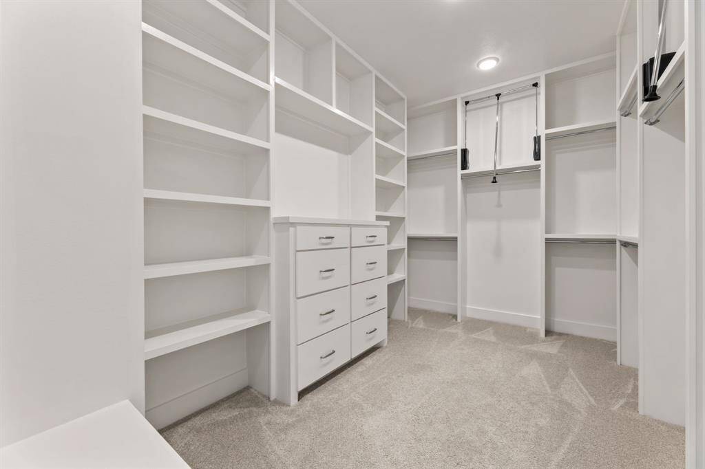 Expansive his and her walk-in closets for ample storage and organization.
