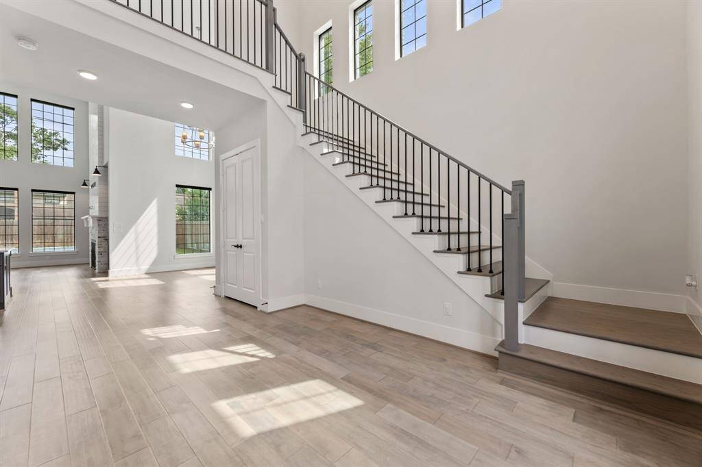 Welcome to an inviting foyer featuring high ceilings, abundant natural light, and sleek modern finishes.