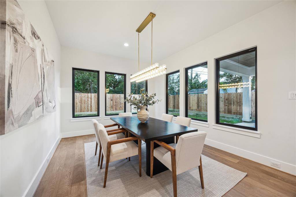 The dining room with dazzling chandelier looks out onto the porch and to the backyard.