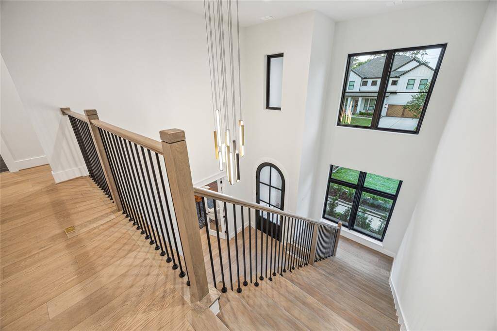 The open, two-story foyer has a beautiful cascading chandelier.