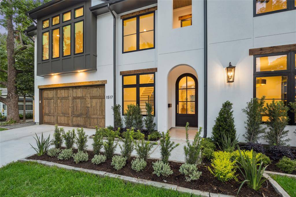 Enter through the oversized arch-top iron door with beautiful gold Emtek handleset.