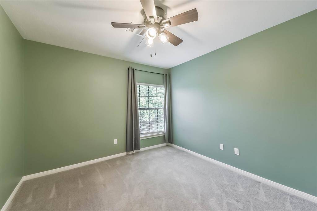 This spacious secondary bedroom on the second floor offers comfort and flexibility. The room features walk-in closet and a ceiling fan for added comfort. Generous wall space allows for easy furniture arrangement and personal touches.