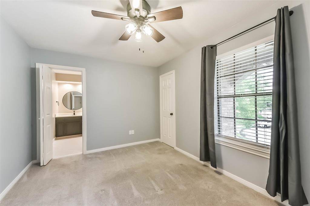 This inviting secondary bedroom features two spacious closets and a private ensuite bathroom, offering comfort and convenience for guests or family members. The ensuite bathroom is easily accessible, enhancing the room’s functionality. With thoughtful layout and stylish touches, this space is both practical and serene.
