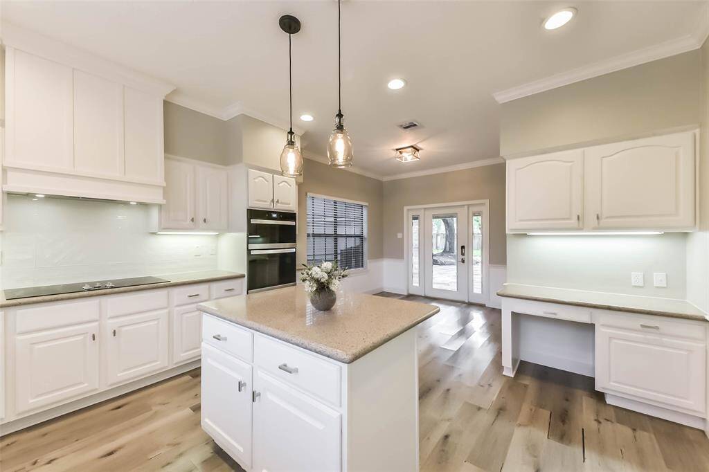 The kitchen layout includes a built-in command center and a cozy breakfast area with access and views and of the backyard through double glass doors. With its open flow and natural light, this kitchen is perfect for everyday living and entertaining. With its open flow, this kitchen is perfect for everyday living and entertaining. Virtually staged