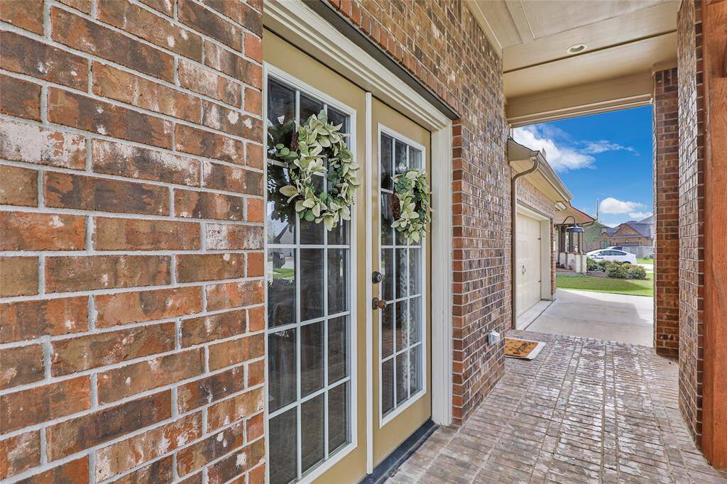 Beautiful French doors from home office/study onto the front porch. Great view to watch kids play or relax in the morning.