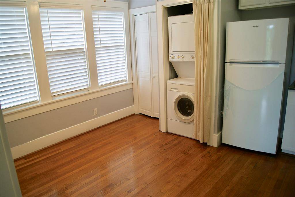 Dining area of big, eat-in kitchen with hardwood floors.  Refrigerator, microwave, stacked washer and dryer included in lease.