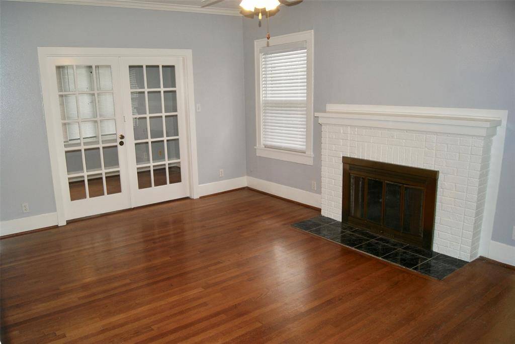 Large 18 ' x13' Living Room with gleaming hardwood floors and fireplace. French doors open to 13' x 8' Sunroom or office.