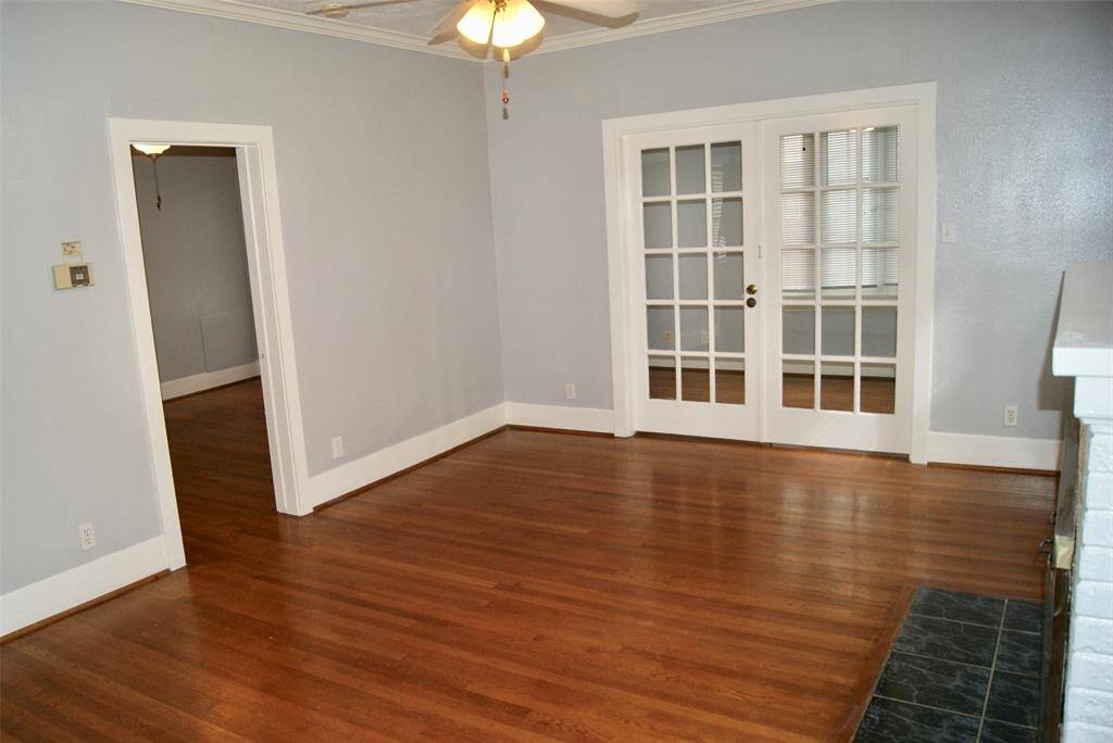 Large 18 ' x13' Living Room with gleaming hardwood floors and fireplace. French doors open to 13' x 8' Sunroom or office.