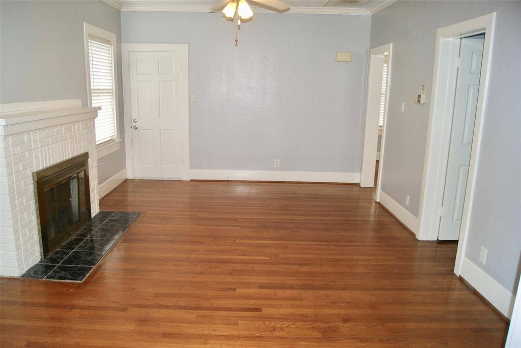 Another view of the large 18 ' x13' Living Room with gleaming hardwood floors and fireplace.