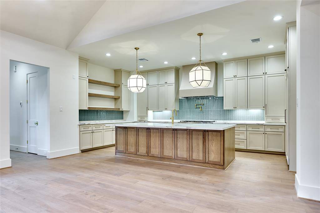 This kitchen features abundant storage with custom made cabinetry crafted by Kent Moore.