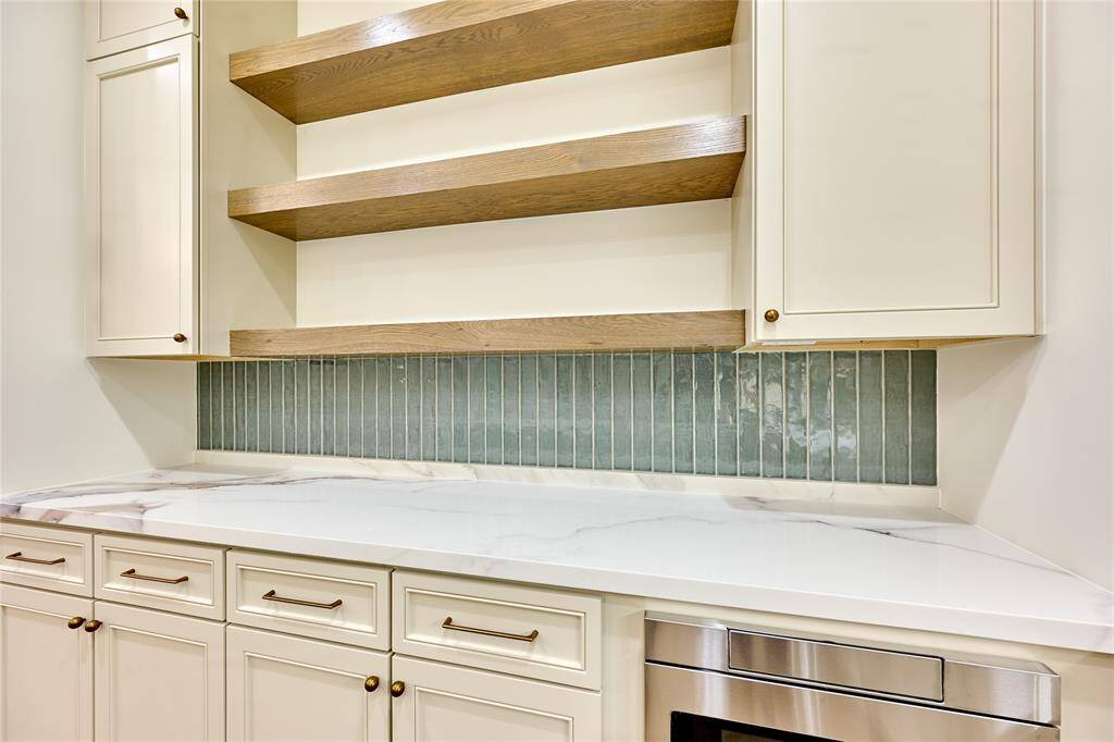 Wooden shelves provided for additional storage and create an open, are feel, enhancing space with both function and style.