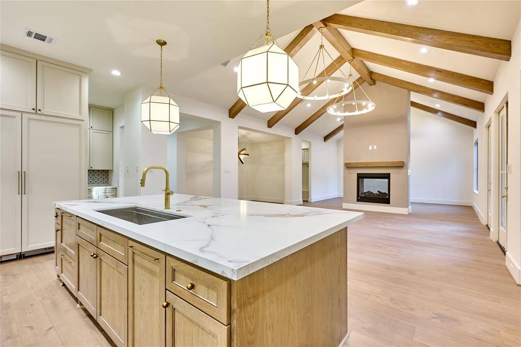 Open concept kitchen seamlessly flows into the living room, creating a spacious and connected environment.