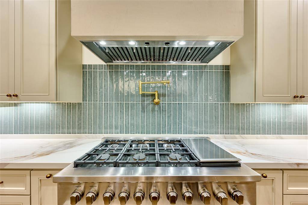 Featuring a convenient pot filler and a 48" gas range.