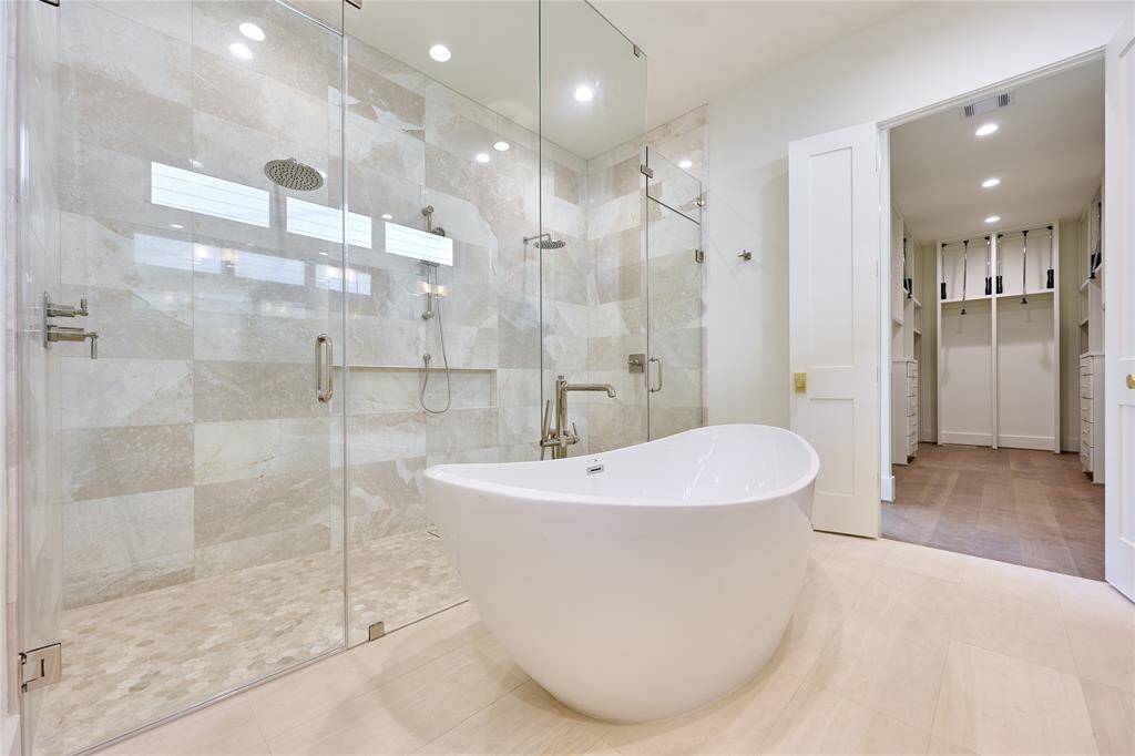 Luxurious primary bath featuring an elegant oval-shaped soaking tub.