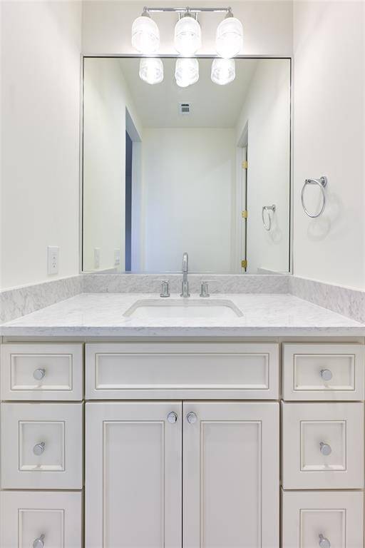 The Jack and Jill bathroom is thoughtfully designed with dual sinks, each featuring sleek quartz countertops, providing both style and practicality for shared use between the two bedrooms.