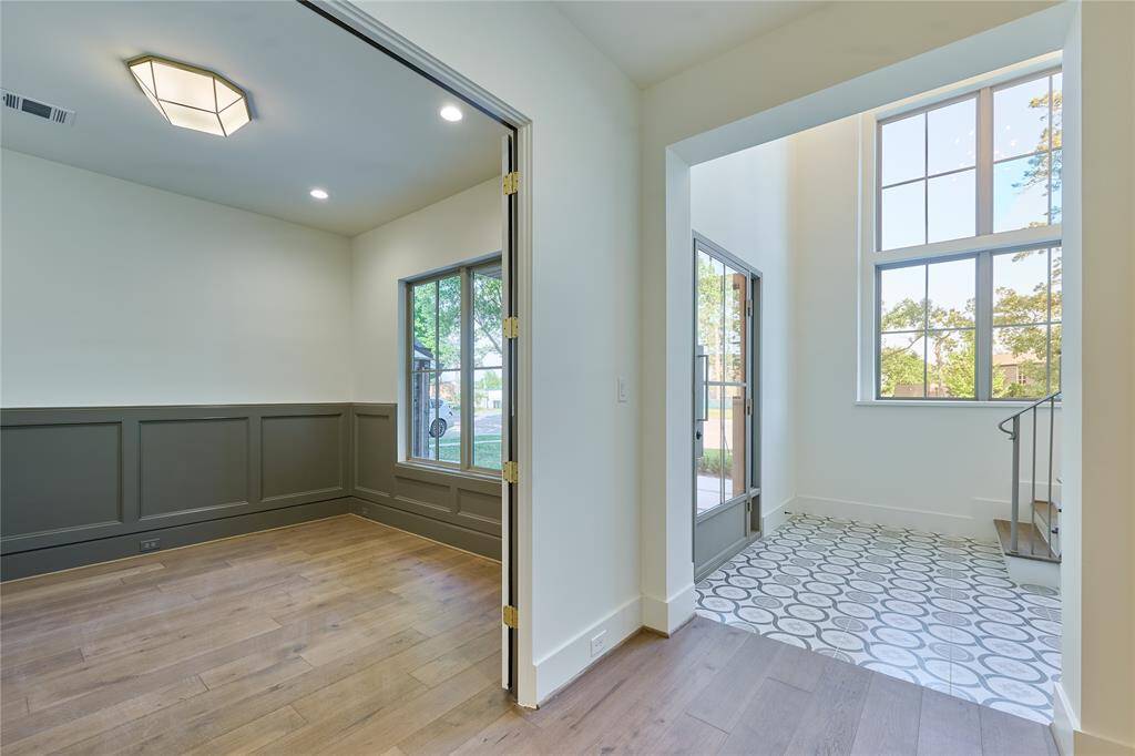 Welcome open foyer with a view of the office/study, creating a warm and elegant feel.