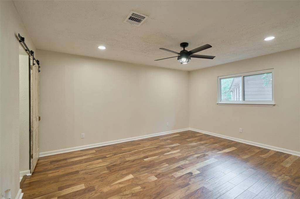 Primary bedroom upstairs with large walk in closet with organization system.