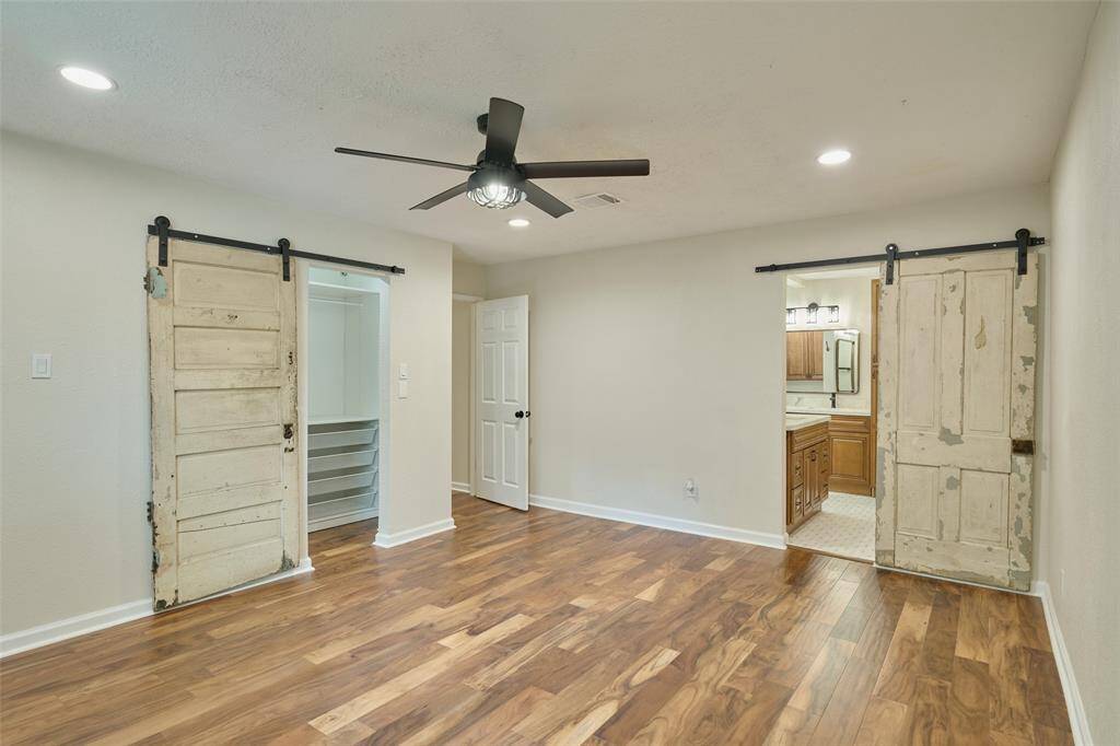 Barn doors on closet space and primary bath