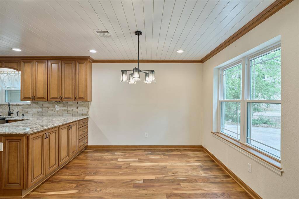 Light and bright dining area on front of house open to kitchen