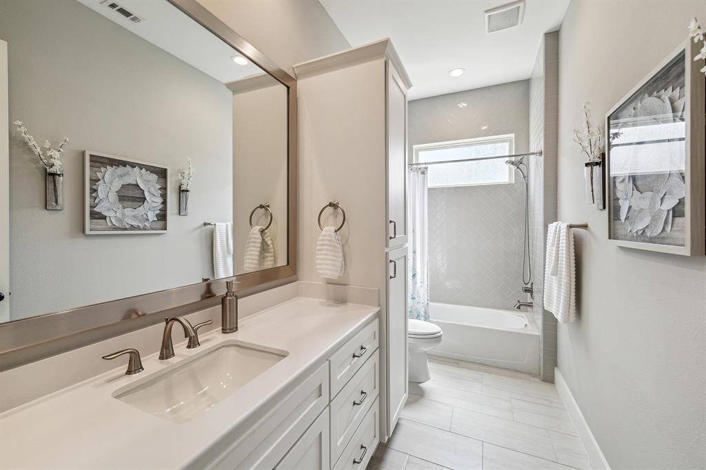 Secondary bath on the first floor with shower/tub combo, Granite countertop and ample storage.