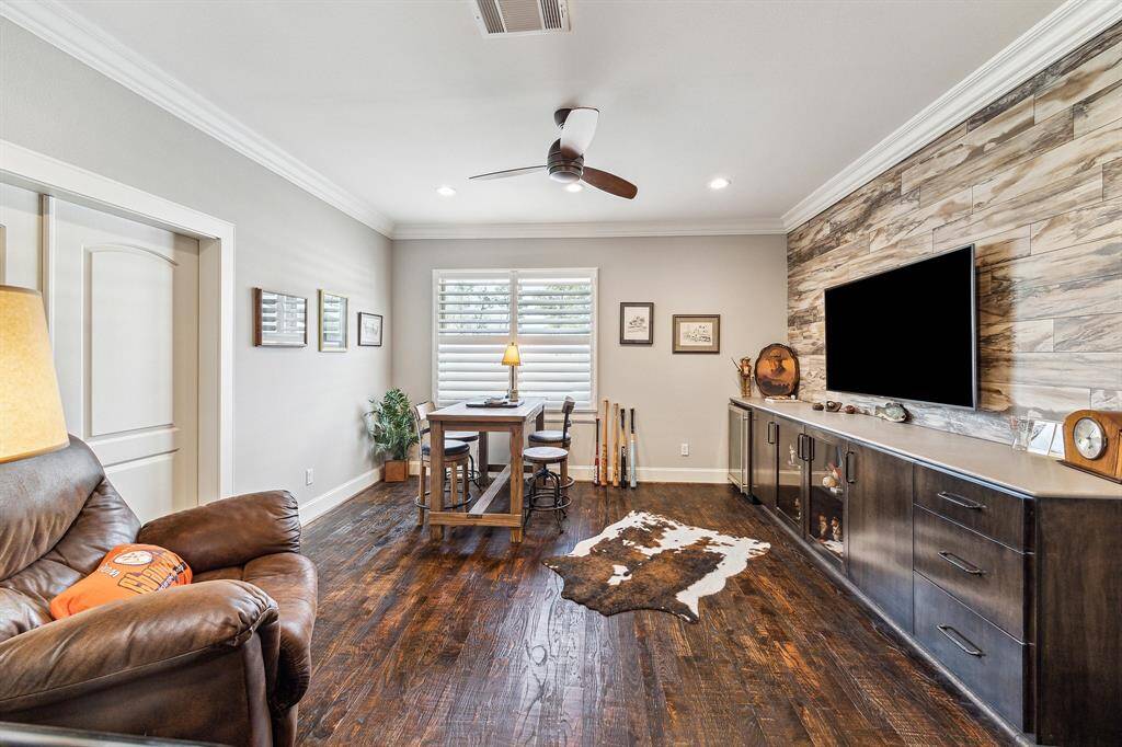 Spacious man cave on the second floor, featuring scraped oak wood flooring. This versatile space also includes a full bath and ample closet storage.