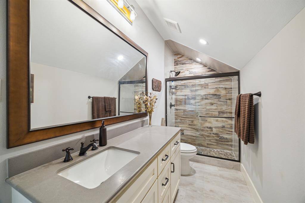 Second floor bath with walk-in shower and granite countertop.