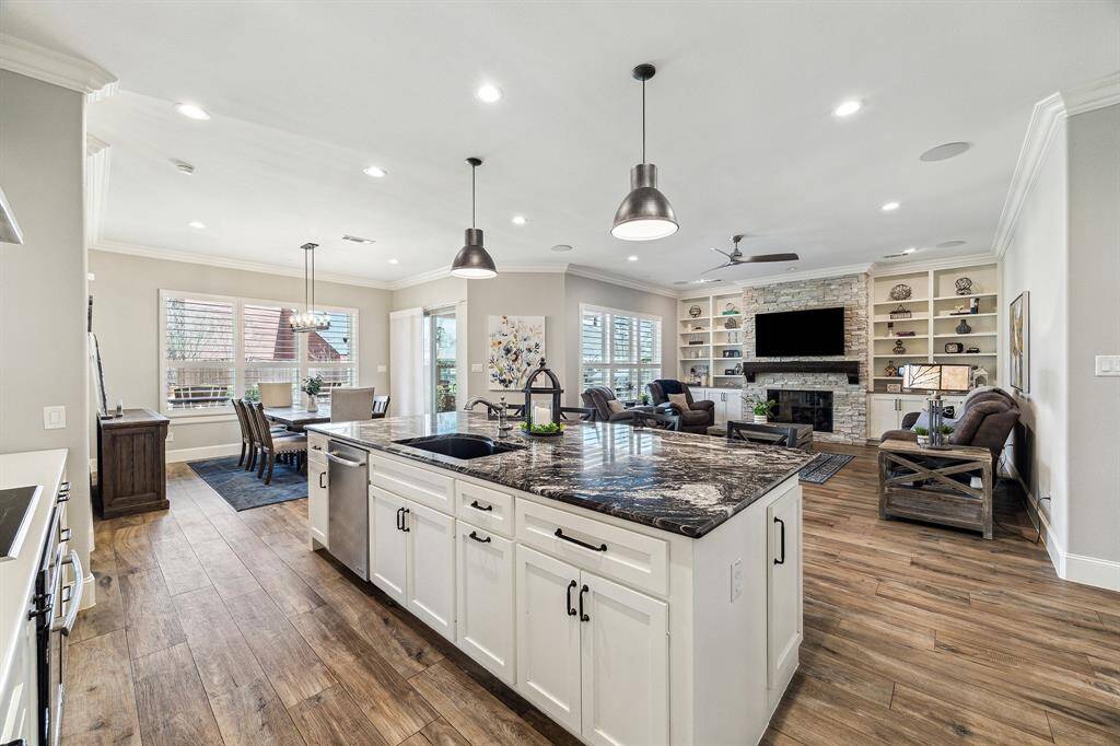 Kitchen has a seamless flow into the dining and living areas. The island features ample storage and undermount sink.