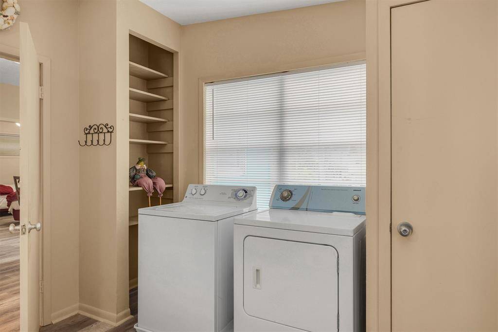 washer and dryer area with genorous shelving.