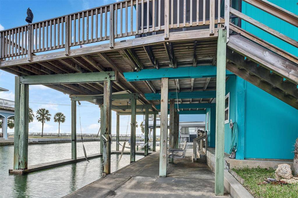 Underside of home with swing and boat lift.