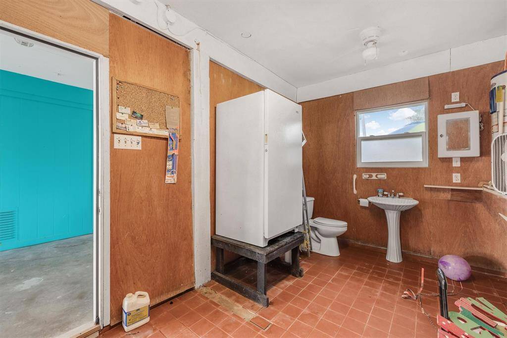 Half bath on ground floorwith free stnding freezer and lot of storage.