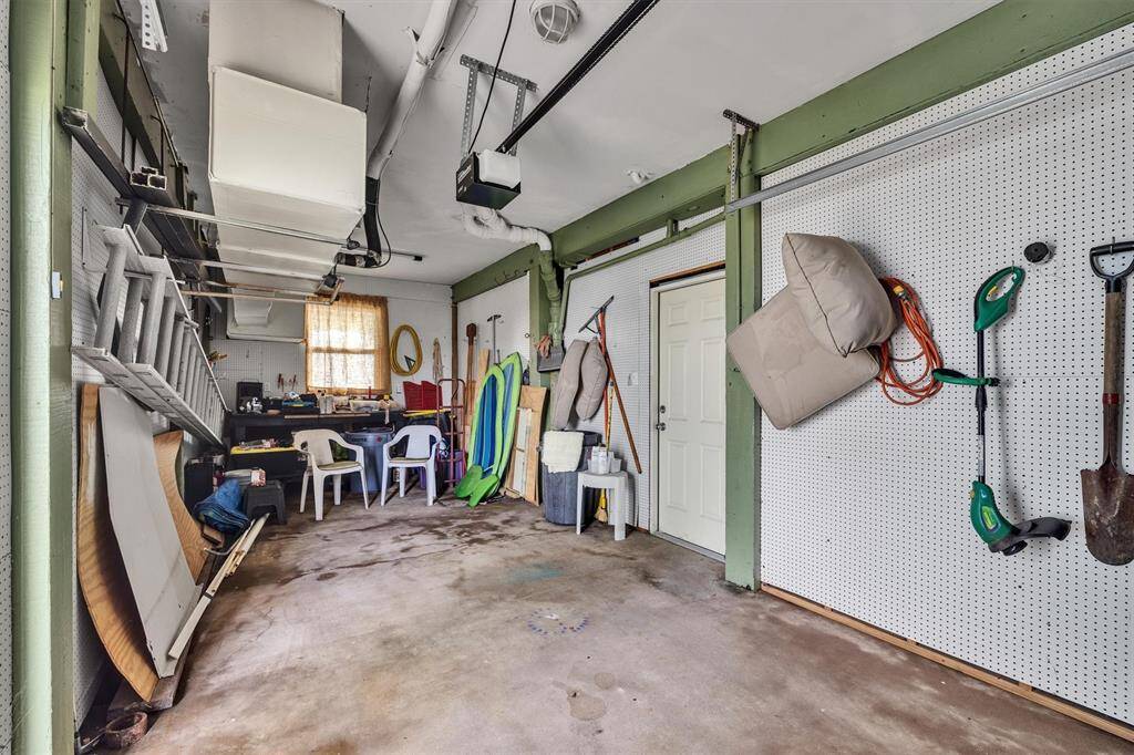 Gound floor garage with an electric door and plenty of storage.