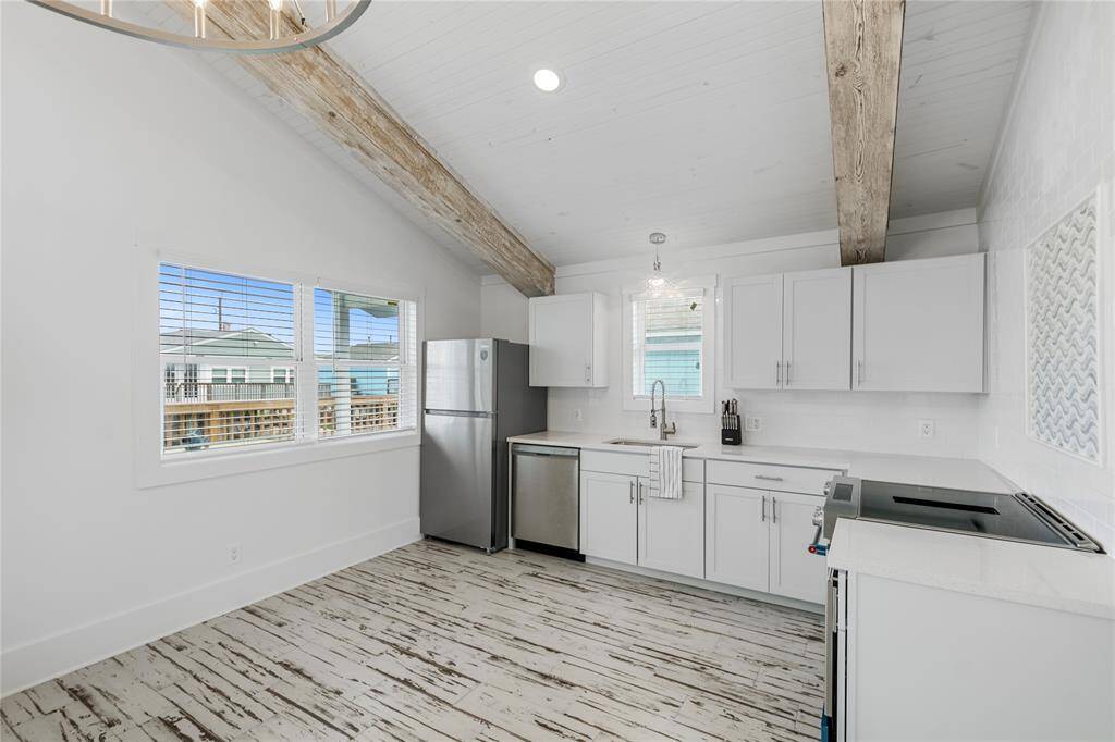 Walked thru the glass sliding door, inside the cottage is the open-concept living space featuring bright, lots of natural light, and full of coastal charm.