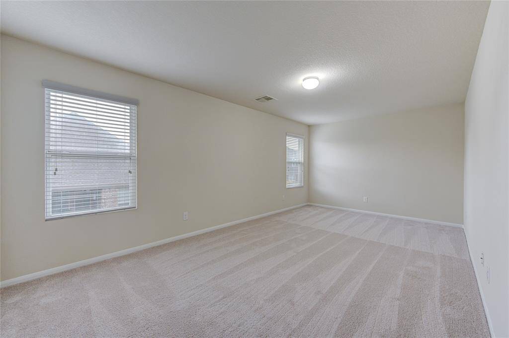 The first of two upstairs secondary bedrooms is a good size with a nice sized closet!