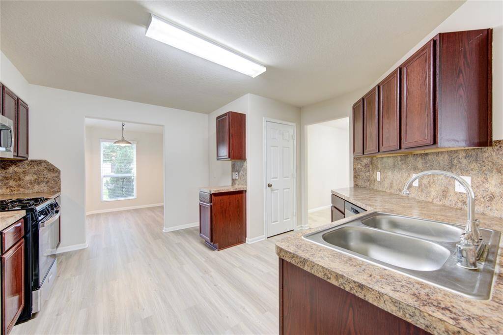 The open floor plan connects the kitchen seamlessly to the breakfast room, dining room, and living room!