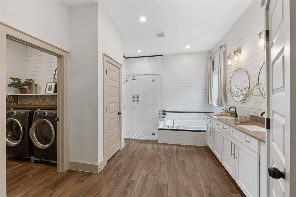 This spa-like retreat includes an oversized walk-in shower and upgraded finishes, enhancing the home’s elegant design.