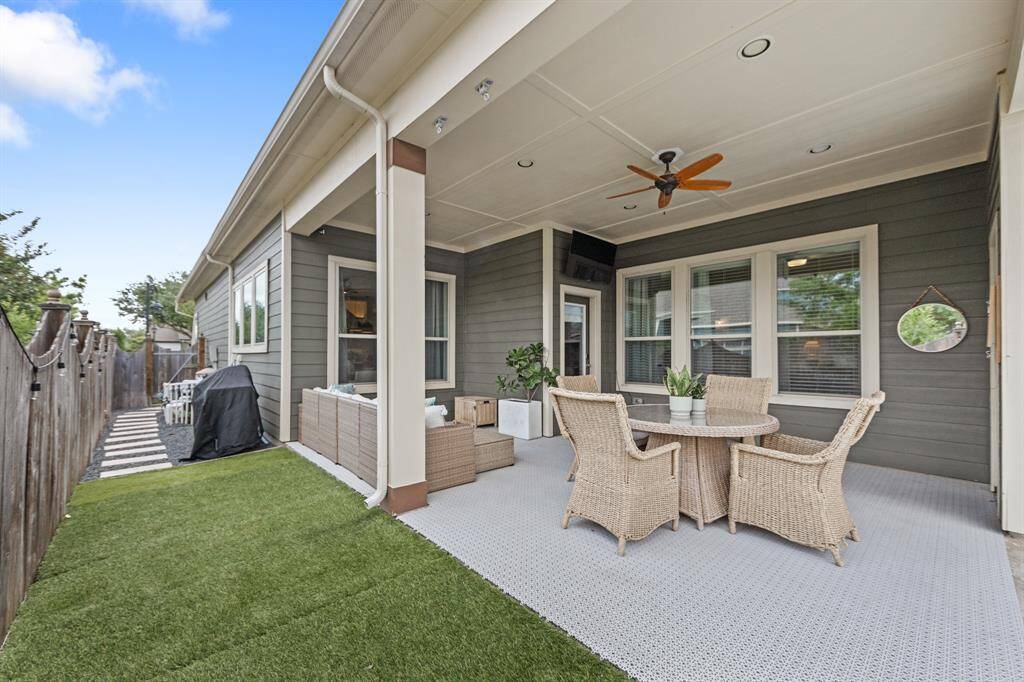 Outdoor lounging space near the heated pool, ideal for relaxing or entertaining. The ceiling fan enhance comfort in the Texas heat.