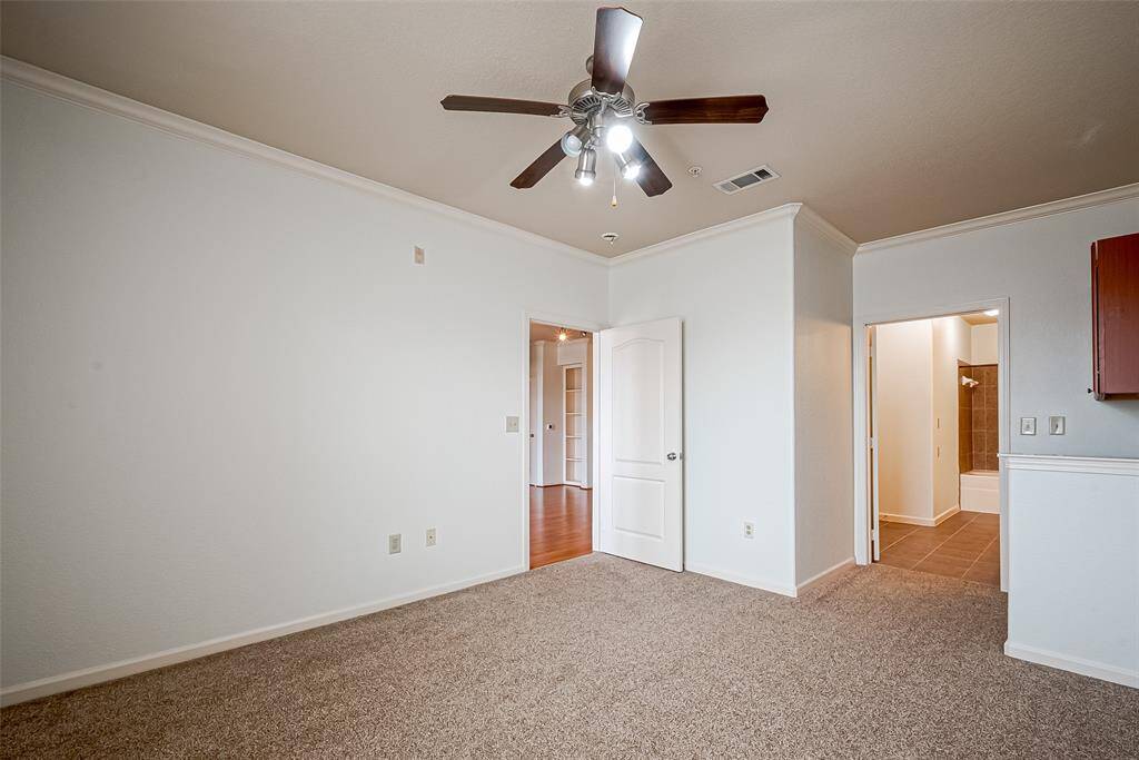 Gain access to a bathroom with tile flooring. It includes a doorway leading to another room with hardwood flooring, creating a seamless transition between spaces.