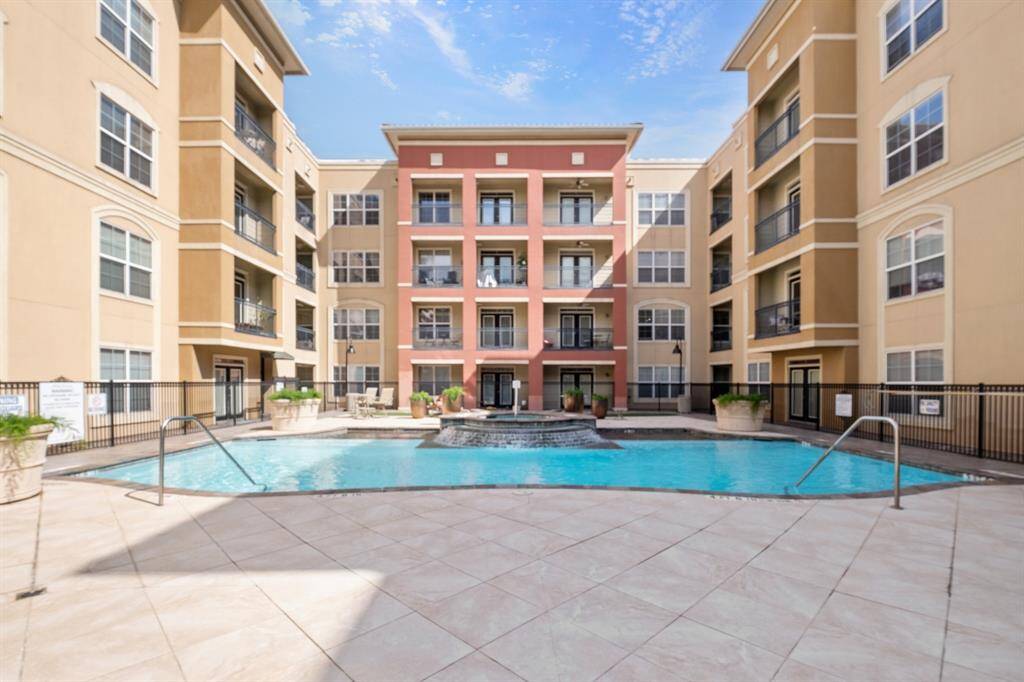Central courtyard with a large swimming pool, surrounded by multi-story buildings, 4 floors. Ideal for residents seeking amenities and community living.