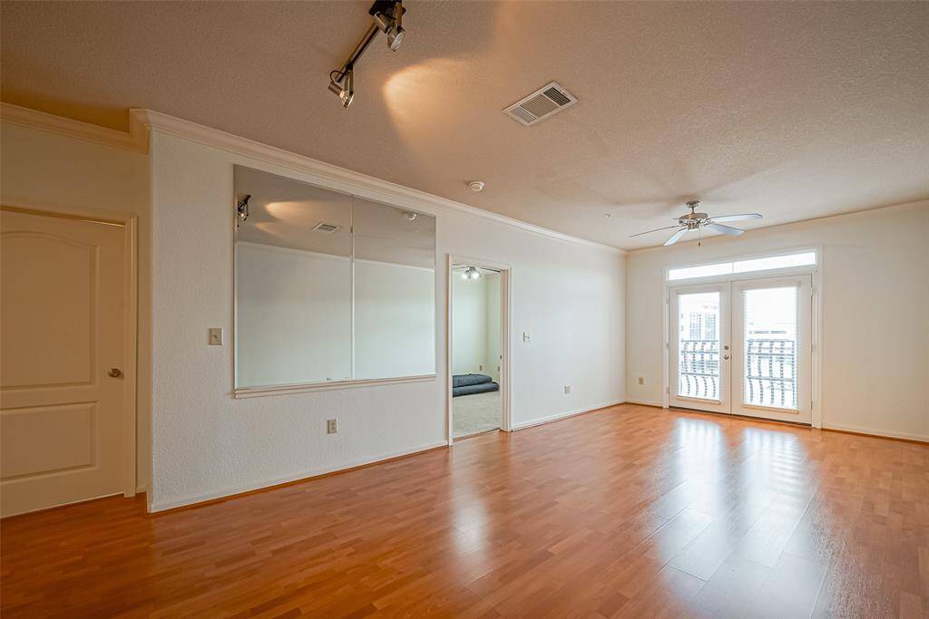 A mirrored wall enhances the sense of space, and an adjacent room offers versatility.