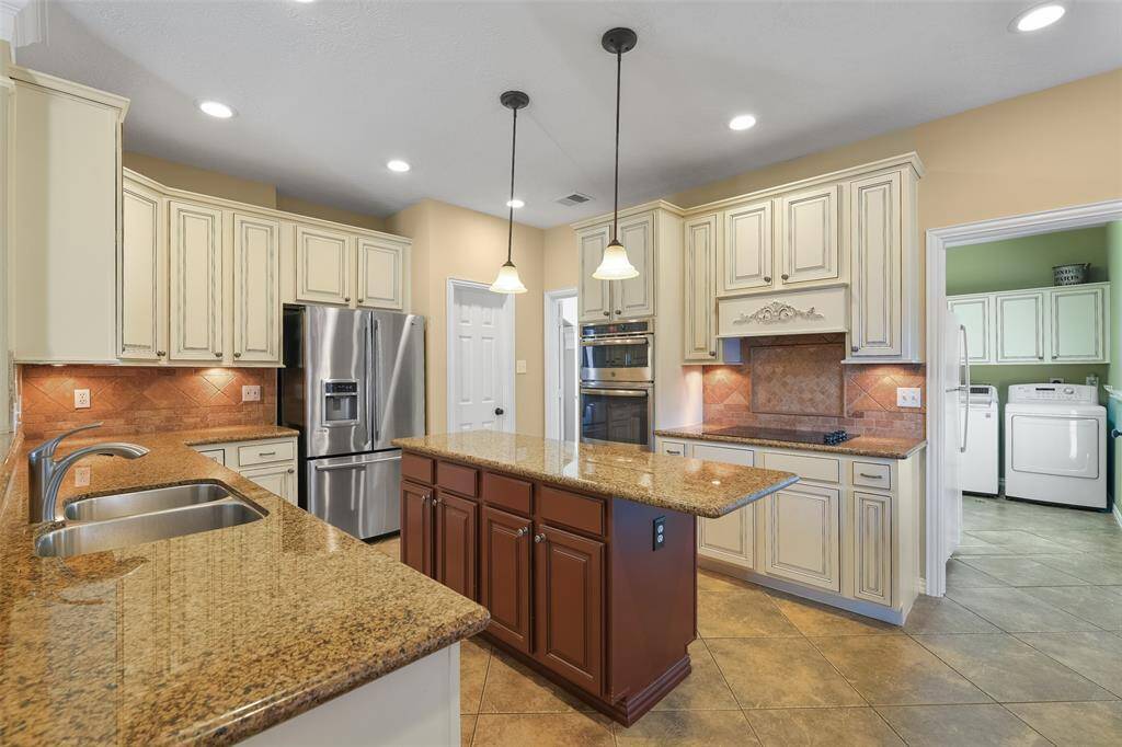 The chef of the house is sure to appreciate the dual basin sink, the large walk-in pantry, and the stainless appliances that include a wall microwave and single oven, a concealed control dishwasher, and a smooth glass cooktop.