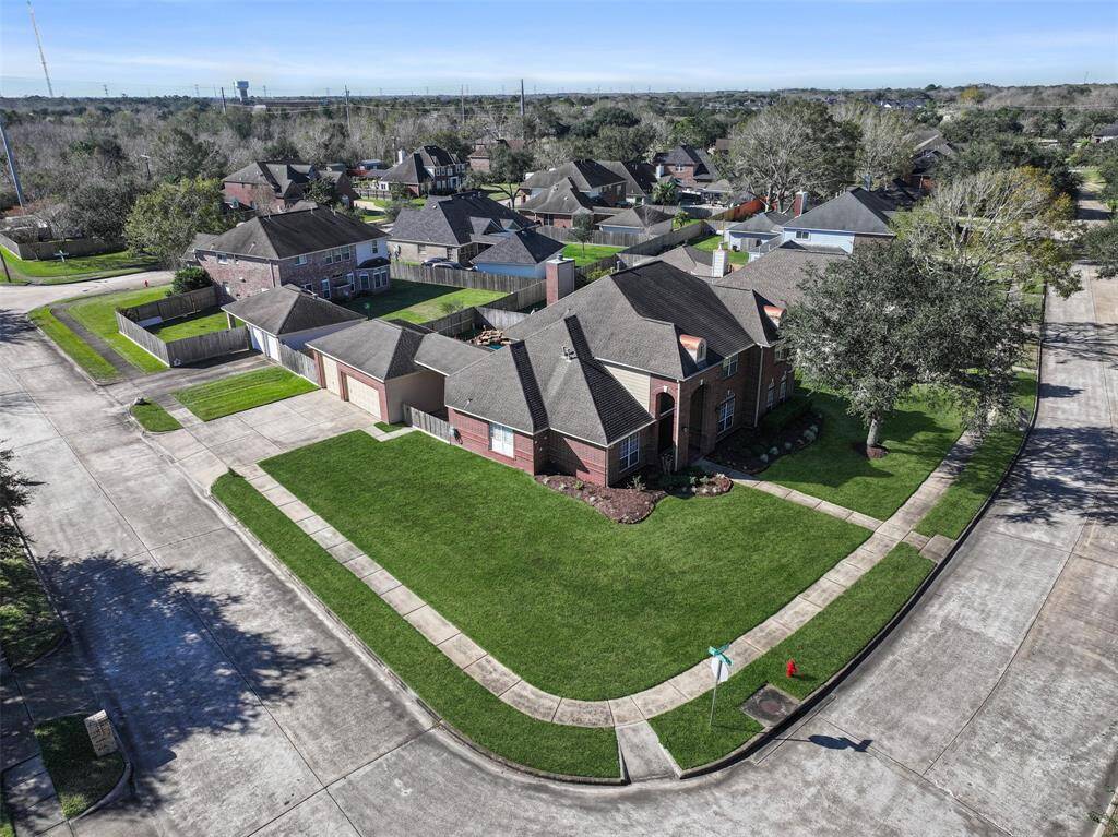 One especially unique and noteworthy feature of this home is the side-facing three-car garage with a triple-wide driveway. The single garage bay boasts an oversized 9-foot high door and there is also a side gate and a space to park a trailer to the left of the garage.