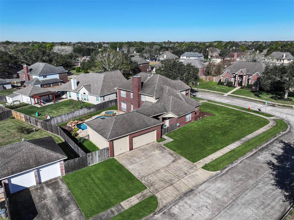 One especially unique and noteworthy feature of this home is the side-facing three-car garage with a triple-wide driveway. The single garage bay boasts an oversized 9-foot high door and there is also a side gate and a space to park a trailer to the left of the garage.