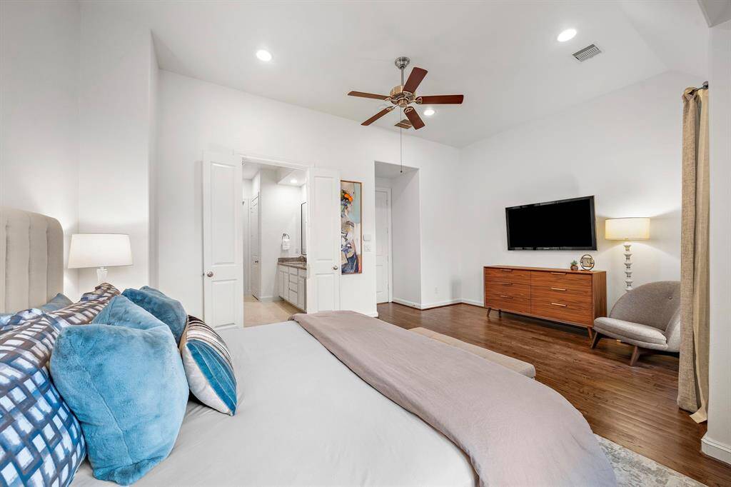 Spacious enough for a media setup and additional furnishings, the primary bedroom offers flexibility for both comfort and function.