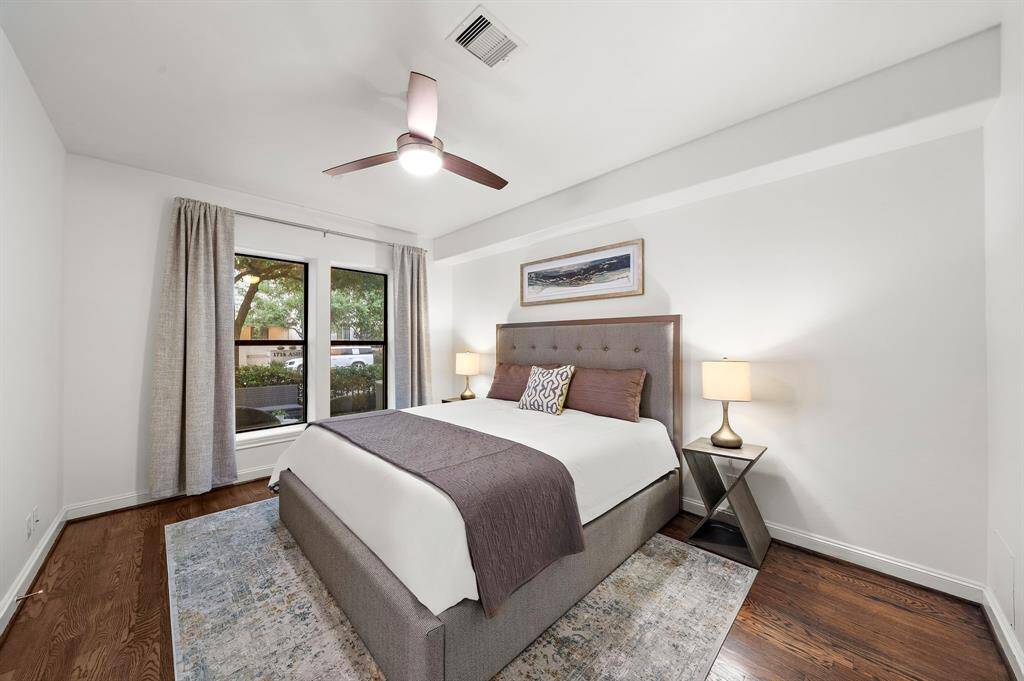 A frameless walk-in shower and oversized tub offer spa-like amenities, with a clear sightline back to the bedroom that enhances the suite’s connected flow and privacy.