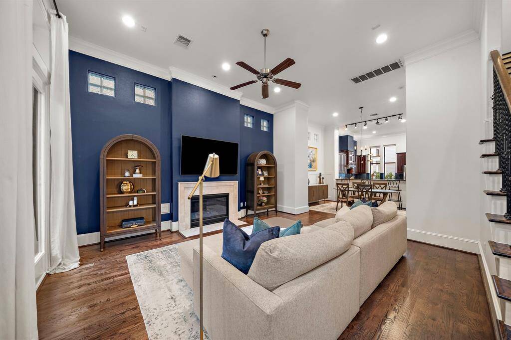 The open layout connects the living area to the kitchen and dining spaces, making it ideal for entertaining while preserving a sense of comfort and flow throughout the main floor.