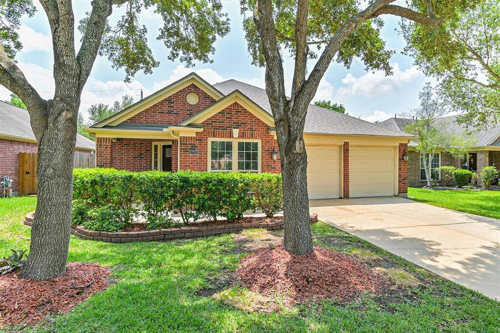 Charming single-story brick home with a welcoming front porch,